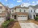 Inviting two-story home featuring stone accents and a two-car garage on a sunny day at 105 Concordia Woods Dr, Morrisville, NC 27560