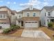 Charming exterior featuring stone details, a two-car garage and a well-manicured lawn at 105 Concordia Woods Dr, Morrisville, NC 27560