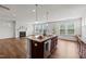 Open kitchen featuring a granite island with a stainless steel sink, and a view of the living room at 105 Concordia Woods Dr, Morrisville, NC 27560