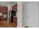 Well-equipped kitchen with dark cabinets, stainless appliances, and built-in shelving at 105 Concordia Woods Dr, Morrisville, NC 27560