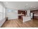 Bright eat-in kitchen with wood floors, a central island with granite countertops, and cherry cabinets at 105 Concordia Woods Dr, Morrisville, NC 27560