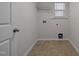 Efficient laundry room featuring tile floor, washer/dryer hookups, and overhead shelving for storage at 105 Concordia Woods Dr, Morrisville, NC 27560