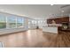 Bright open-concept living room featuring hardwood floors, big windows and a kitchen bar at 105 Concordia Woods Dr, Morrisville, NC 27560