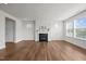 Bright living room with white walls, a black fireplace and big windows at 105 Concordia Woods Dr, Morrisville, NC 27560