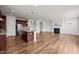 Spacious living room featuring wood floors, an island, and a cozy fireplace at 105 Concordia Woods Dr, Morrisville, NC 27560