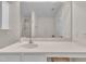 Bright bathroom featuring a sleek vanity and a large mirror reflecting a glass-enclosed shower at 10707 Edmundson Ave, Raleigh, NC 27614