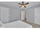 Neutral bedroom offering a ceiling fan and multiple doors enhancing functionality and spaciousness at 10707 Edmundson Ave, Raleigh, NC 27614