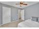 Well-lit bedroom featuring neutral walls, a ceiling fan, and a bed with a window at 10707 Edmundson Ave, Raleigh, NC 27614