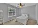 Inviting bedroom features a ceiling fan and a window illuminating a cozy bed with white bedding at 10707 Edmundson Ave, Raleigh, NC 27614