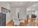 Formal dining area with hardwood floors, a chandelier, and white chairs at 10707 Edmundson Ave, Raleigh, NC 27614