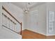 Inviting entryway boasts hardwood floors, a staircase, a chandelier, and plenty of natural light at 10707 Edmundson Ave, Raleigh, NC 27614