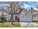 Charming two-story home with a two car garage and a well-manicured lawn at 10707 Edmundson Ave, Raleigh, NC 27614