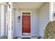 View of the front door of the house with sidelight and house number at 10707 Edmundson Ave, Raleigh, NC 27614