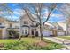 Charming home with a well-manicured lawn, mature tree, and a two-car garage at 10707 Edmundson Ave, Raleigh, NC 27614