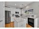 Bright kitchen features white cabinets, stainless steel appliances, and a functional island at 10707 Edmundson Ave, Raleigh, NC 27614