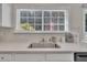A stainless steel sink and granite countertops, complemented by white cabinets and modern finishes, are the focal point at 10707 Edmundson Ave, Raleigh, NC 27614