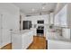 Bright kitchen features white cabinets, an island, and stainless steel appliances at 10707 Edmundson Ave, Raleigh, NC 27614
