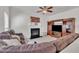 Cozy living room showcases fireplace, mounted television, and plush sectional sofa at 10707 Edmundson Ave, Raleigh, NC 27614