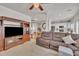 Open-concept living area with cozy brown sofa, large TV, and open access to the kitchen at 10707 Edmundson Ave, Raleigh, NC 27614
