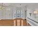 Inviting living room with gleaming hardwood floors, a bay window, and a decorative chandelier at 10707 Edmundson Ave, Raleigh, NC 27614