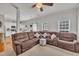 Spacious living area with a large sectional sofa, ceiling fan, and an open view to the kitchen at 10707 Edmundson Ave, Raleigh, NC 27614