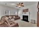 Spacious living room offers a cozy sectional sofa, ceiling fan, and fireplace at 10707 Edmundson Ave, Raleigh, NC 27614