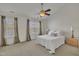 Calm main bedroom offers neutral carpet, a bed, side tables, and natural lighting with bright windows at 10707 Edmundson Ave, Raleigh, NC 27614