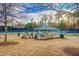 Community picnic area with a green awning, picnic tables, and tennis courts in the background at 10707 Edmundson Ave, Raleigh, NC 27614
