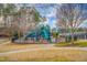 Community playground with slides, climbing structures, and a fenced perimeter at 10707 Edmundson Ave, Raleigh, NC 27614