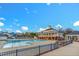 Large community swimming pool and clubhouse with white pillars and brick accents at 10707 Edmundson Ave, Raleigh, NC 27614