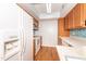 Bright kitchen featuring wooden cabinets, white appliances and laminate floors at 109 Killam Ct # La, Cary, NC 27513