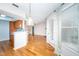 Bright open-concept living space with hardwood floors and a view into the modern kitchen at 109 Killam Ct # La, Cary, NC 27513