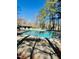 Community pool featuring an adjacent building and surrounded by tall pine trees at 109 Killam Ct # La, Cary, NC 27513