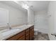 Bathroom features double sinks with granite counters, tile floors and a tub-shower combo at 1103 Apogee Dr, Durham, NC 27713