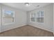 Bright bedroom featuring plush carpeting, neutral walls, and two windows allowing ample natural light at 1103 Apogee Dr, Durham, NC 27713