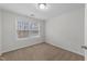 Cozy bedroom boasts neutral walls and plush carpet, illuminated by two bright windows at 1103 Apogee Dr, Durham, NC 27713