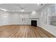 Bright living room with a fireplace, large windows, and hardwood flooring at 1103 Apogee Dr, Durham, NC 27713