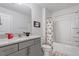 This bathroom features a sleek vanity with granite countertops and a Mickey Mouse shower curtain at 1123 Latitude Dr, Durham, NC 27713