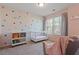 Bright Bedroom with colorful polka dots, plush seating, and a classic white crib at 1123 Latitude Dr, Durham, NC 27713