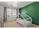 This cozy bedroom features a modern design and a whimsical dinosaur-themed bedspread at 1123 Latitude Dr, Durham, NC 27713