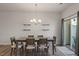 Modern dining room featuring a stylish table set, floating shelves, and natural light at 1123 Latitude Dr, Durham, NC 27713