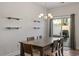 Dining room with modern chandelier, wood table set, and floating shelves at 1123 Latitude Dr, Durham, NC 27713