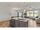 Open concept featuring a granite island with views into the dining and living areas at 1123 Latitude Dr, Durham, NC 27713