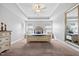 Bedroom features a tray ceiling, neutral décor, and abundant natural light, creating a serene and inviting atmosphere at 115 Cliffview Dr, Garner, NC 27529
