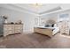 Spacious bedroom boasts a tray ceiling, plush carpet, and abundant natural light, creating a serene retreat at 115 Cliffview Dr, Garner, NC 27529