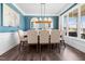 Elegant dining room with stylish decor, a modern chandelier, and plenty of natural light at 115 Cliffview Dr, Garner, NC 27529