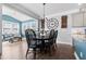 Well-lit dining area with chandelier, dark wood table, and bright windows at 115 Cliffview Dr, Garner, NC 27529