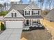 Charming two-story home featuring a covered porch and a stone-accented facade, offering great curb appeal at 115 Cliffview Dr, Garner, NC 27529
