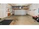 Spacious garage with overhead storage racks and a wall-mounted tool organizer at 115 Cliffview Dr, Garner, NC 27529