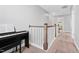 Upstairs hallway with white painted railing and carpeted floor at 115 Cliffview Dr, Garner, NC 27529